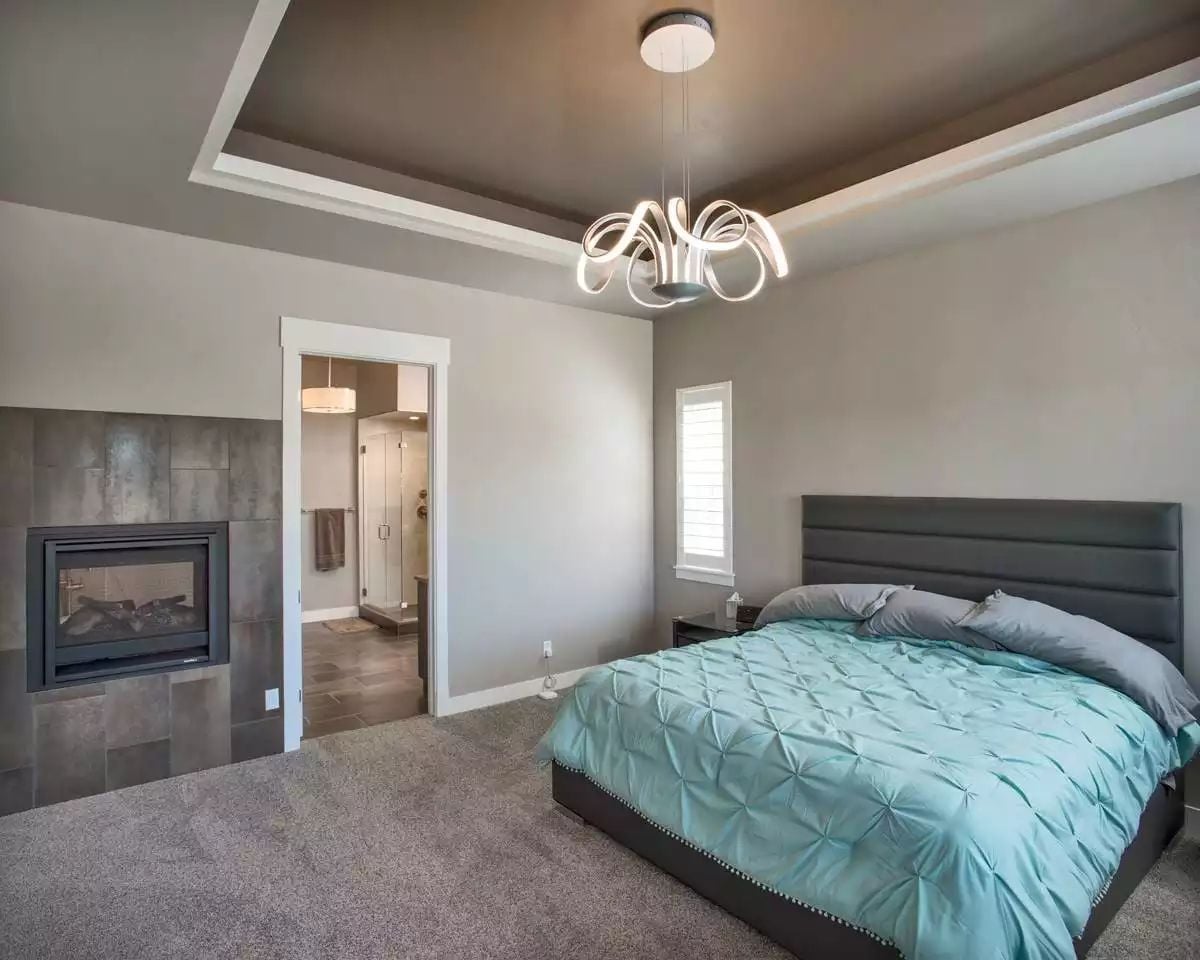 Tray Ceiling Bedroom with Fireplace and Teal Pintuck Bedding