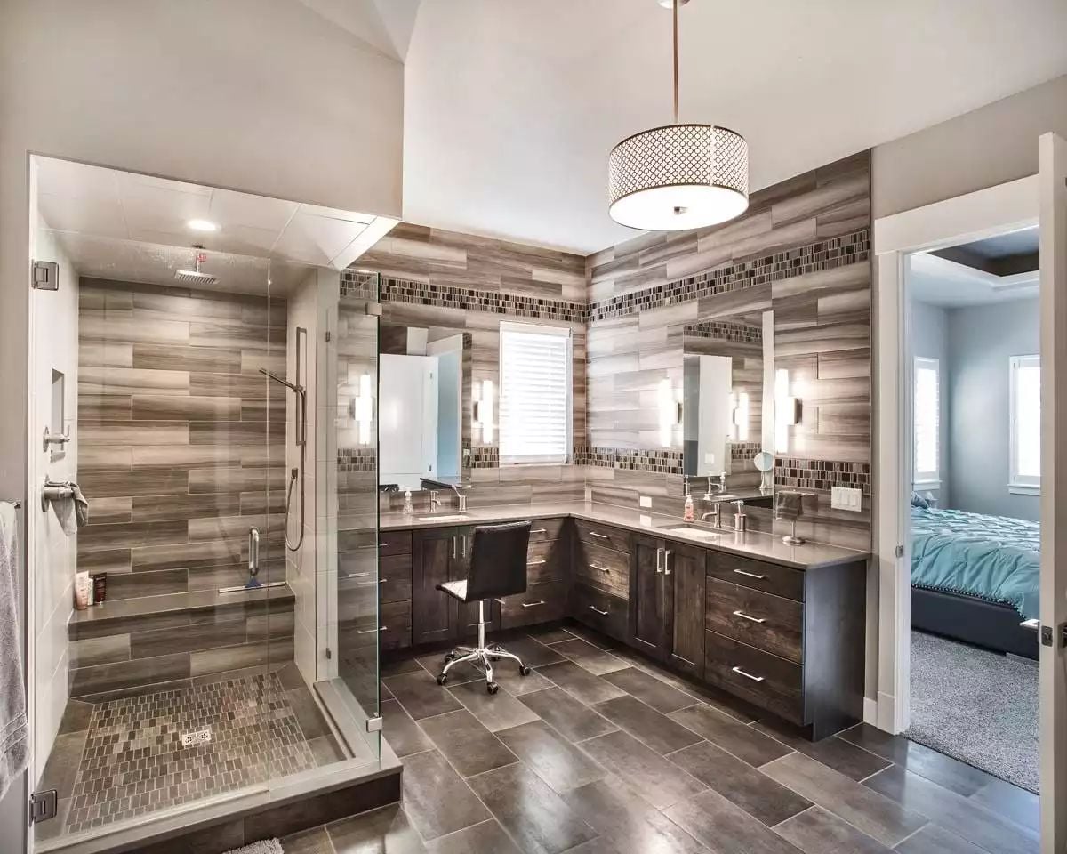 Wood-Look Tile and Dark Vanities Define a Master Bath Built for Two