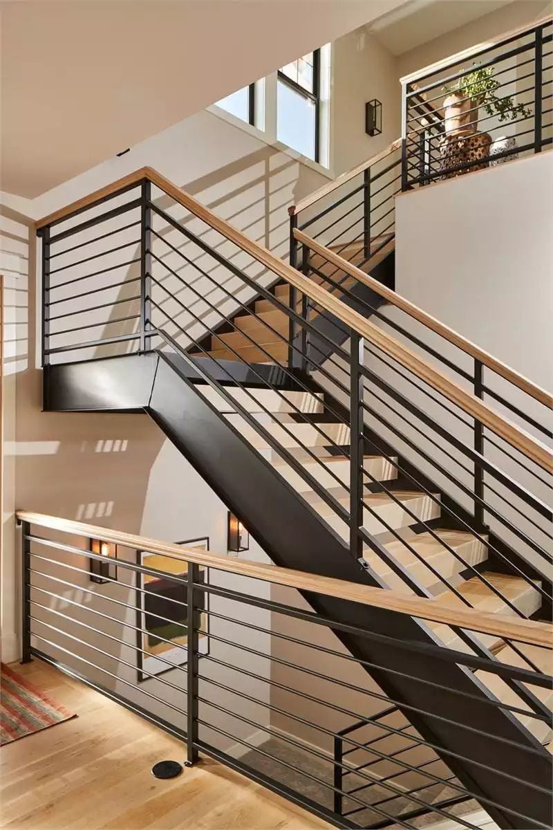 Black Steel and Wood Treads Carry This Staircase Across Three Levels