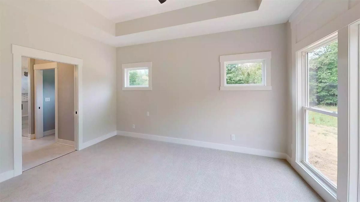Tray Ceiling and Carpet Flooring Define This Quiet Primary Bedroom