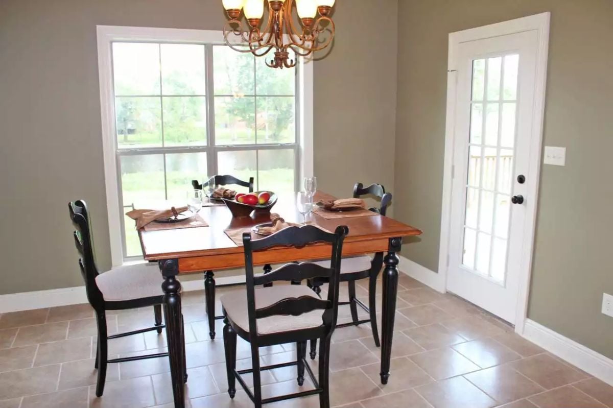 Black Ladder-Back Chairs and a Farmhouse Table Set a Casual Dining Tone