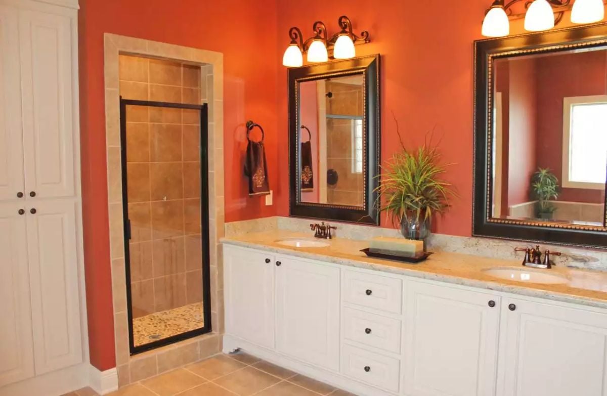 Burnt-Orange Walls and White Cabinetry Make a Bold Statement in This Master Bath