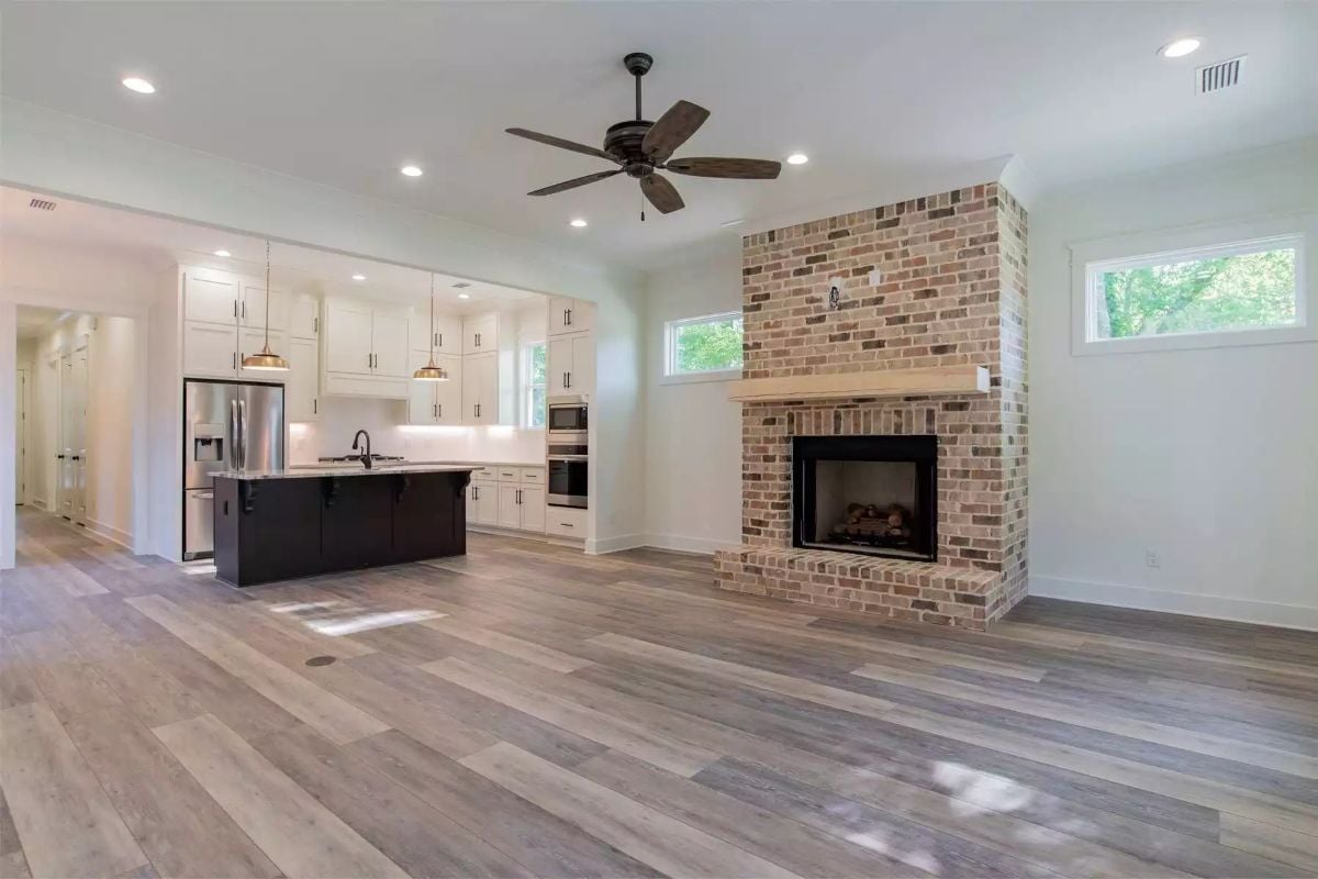 Brick Fireplace Anchors an Open Living Space with Kitchen Views
