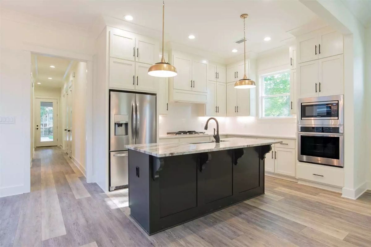 Gold Pendants Drop Over a Black Island Topped with Veined Marble