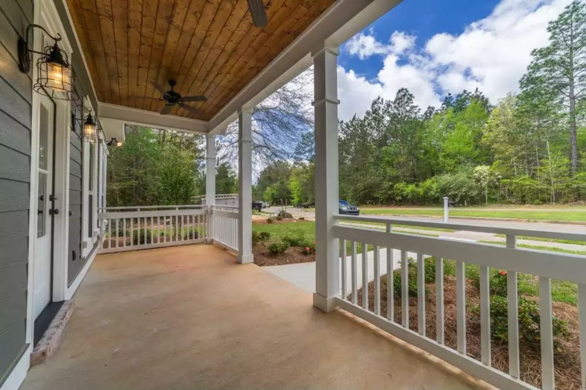 Covered Front Porch with Wood Ceiling, Ceiling Fan, and White Rail Detail