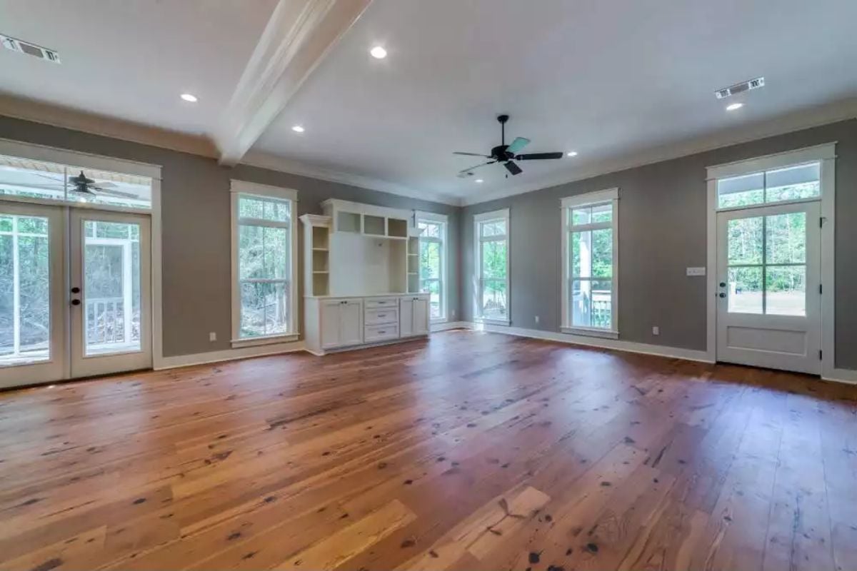 Wide-Plank Pine Floors and Built-In Shelving Define This Open Living Space