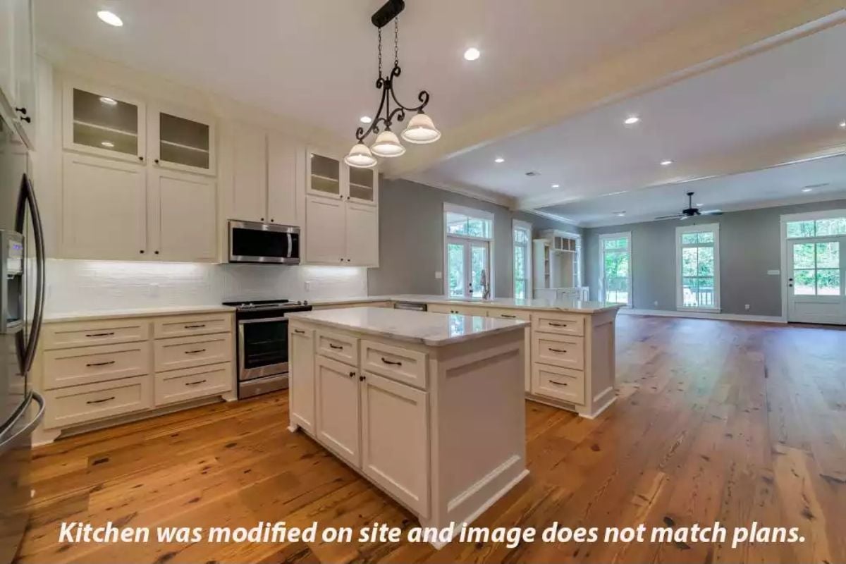White Shaker Cabinets and an Island Light Fixture Anchor This Open Kitchen