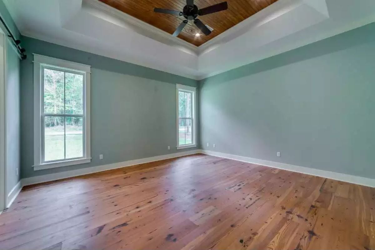 Tray Ceiling with Wood Inset Brings Warmth to This Sage Green Bedroom