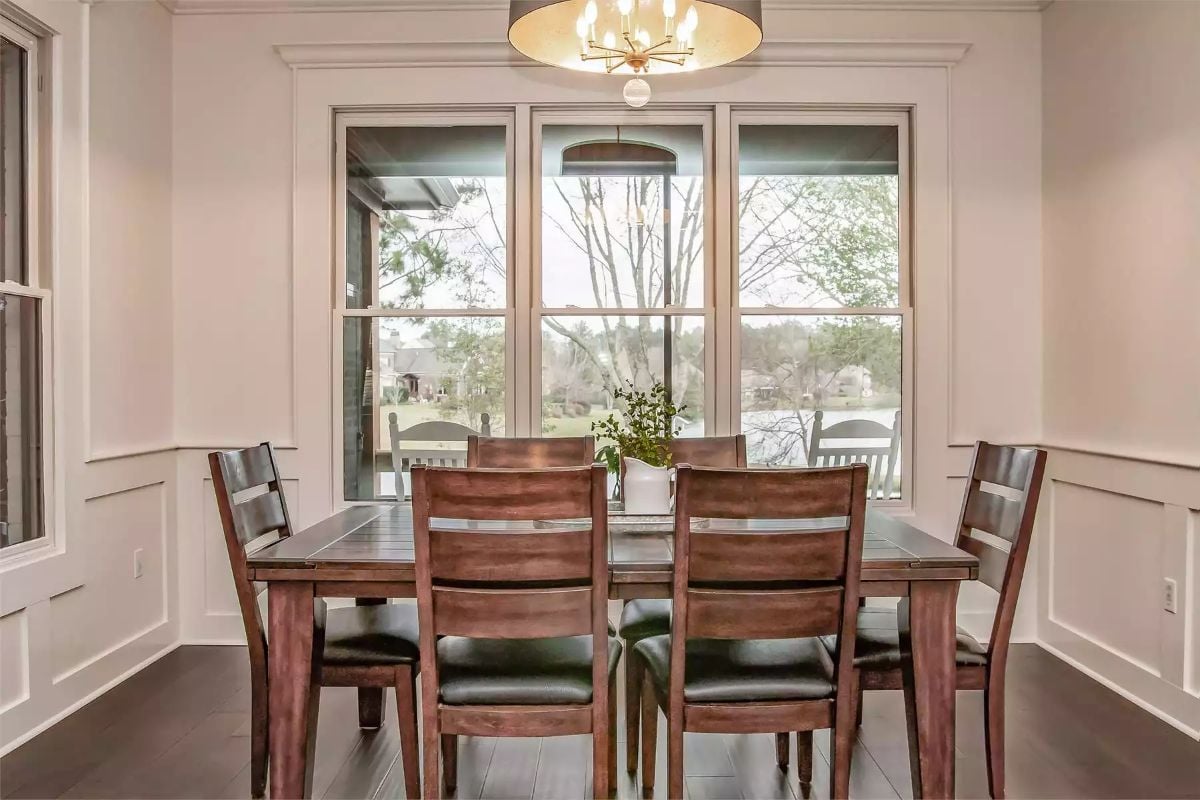 Wainscoting, Dark Wood, and a Lake View Make This Dining Room Worth Lingering In