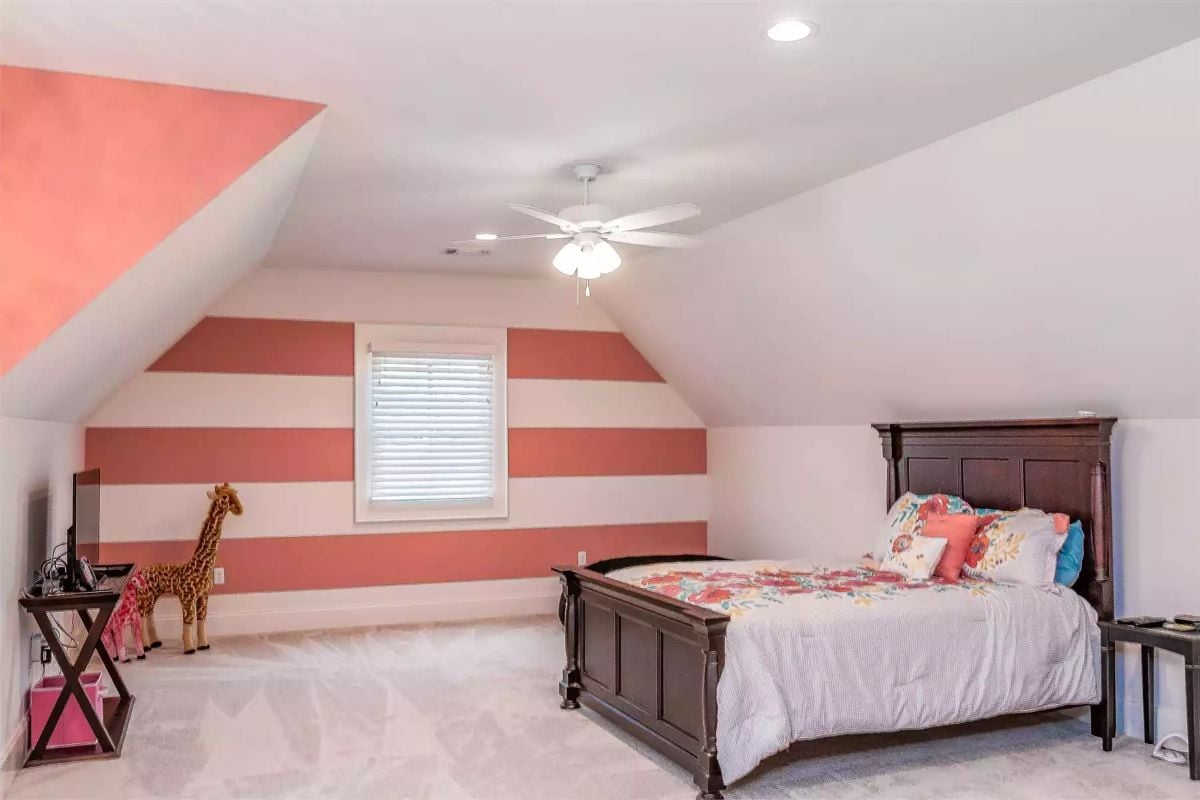 Coral Stripes and a Giraffe Toy Make This Bonus Room Belong to a Kid