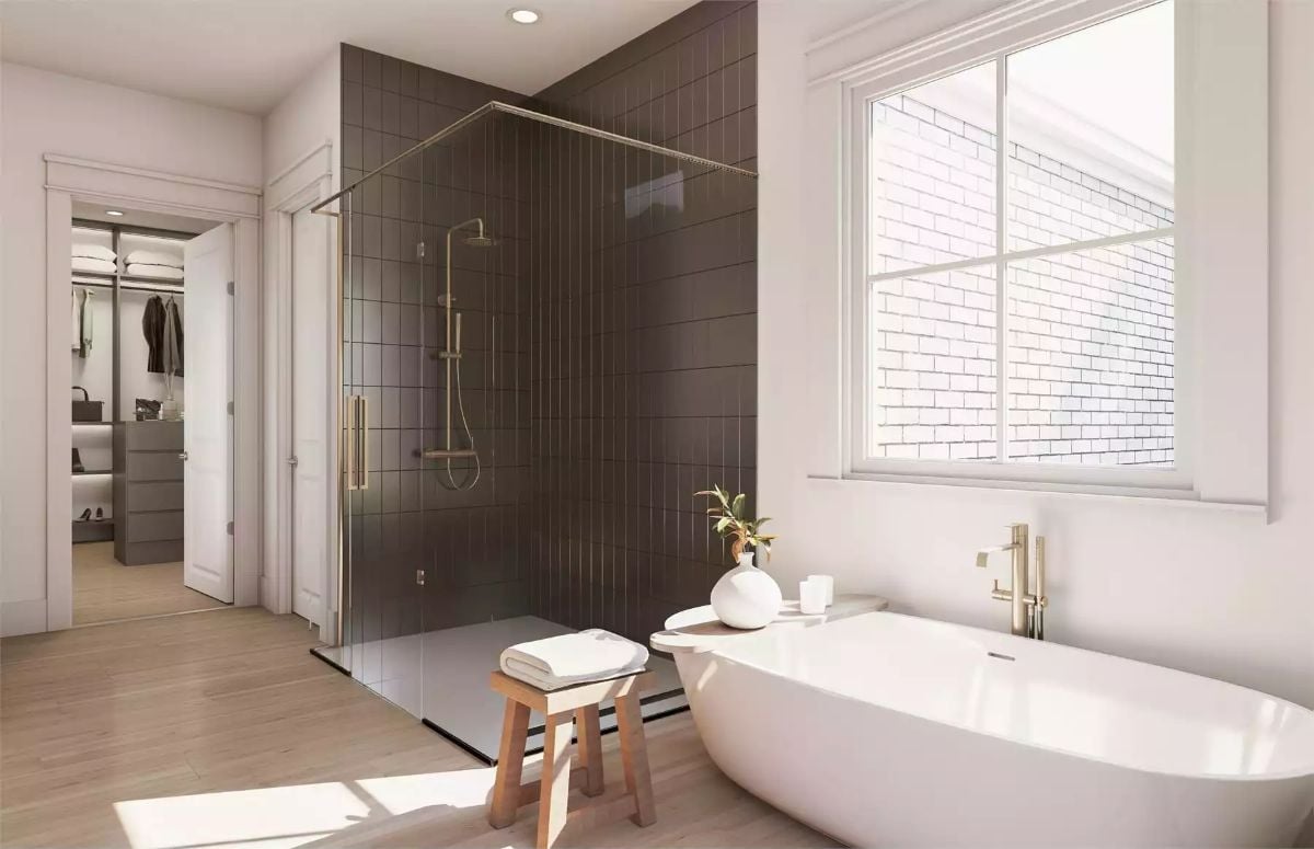 Dark Tile, Brass Fixtures, and a Soaking Tub Make This Bathroom Work Hard