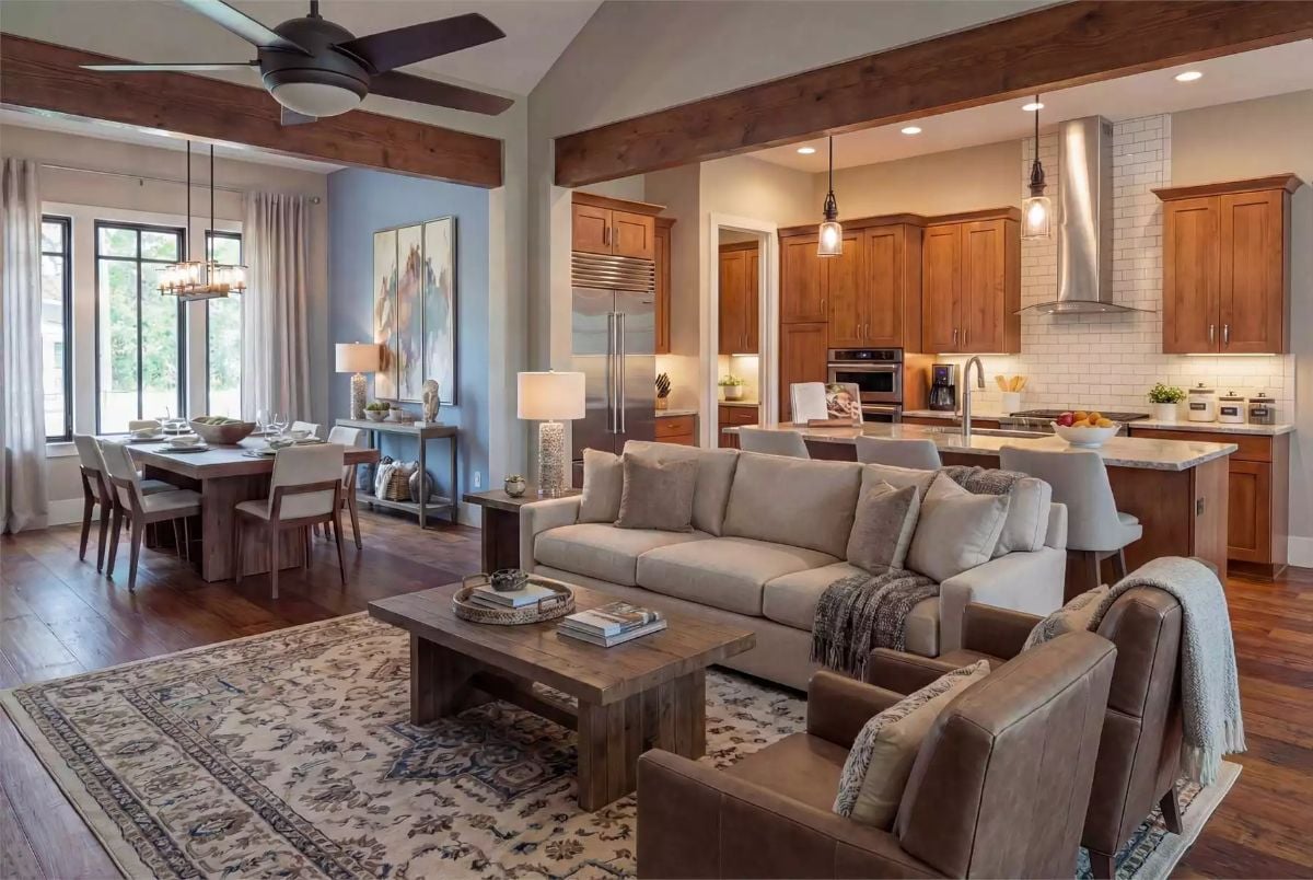 Exposed Beams and Warm Wood Cabinets Anchor an Open-Concept Living Space