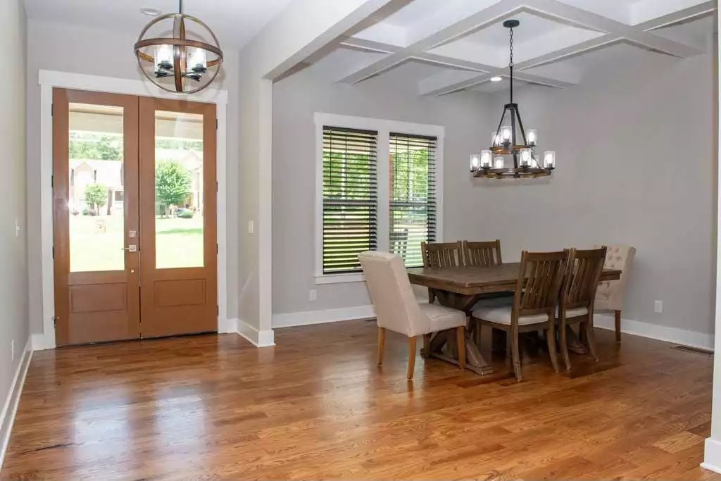 Warm Wood Tones and Coffered Ceilings Define This Farmhouse Dining Space