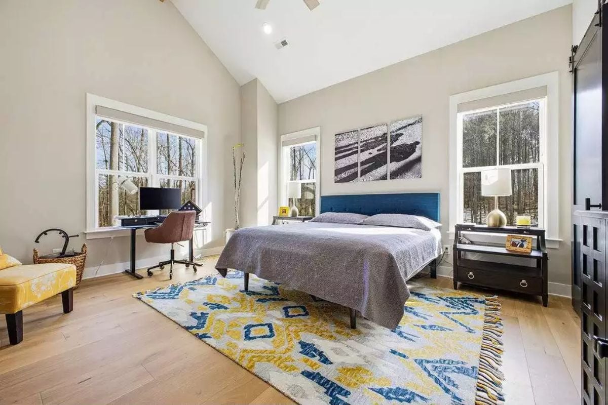 Blue Upholstered Headboard Pulls Color From a Geometric Area Rug