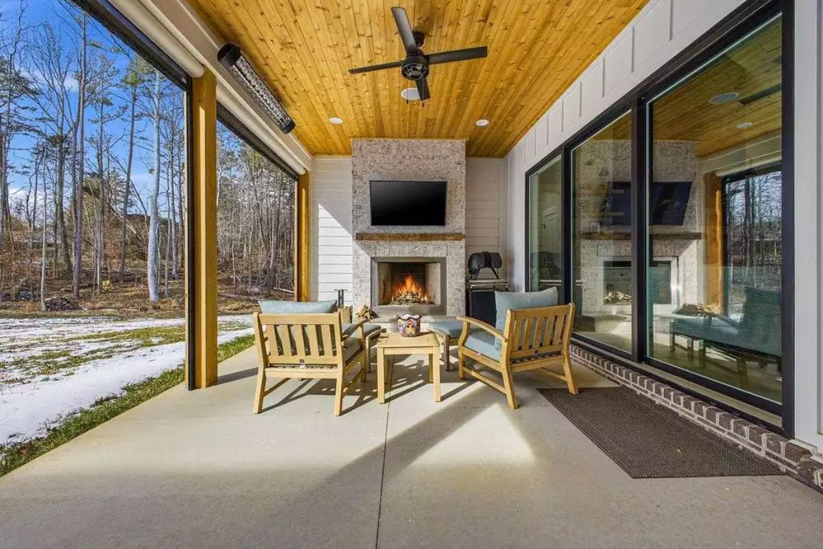 Cedar Ceiling and Stone Fireplace Turn a Covered Patio Into a Four-Season Retreat