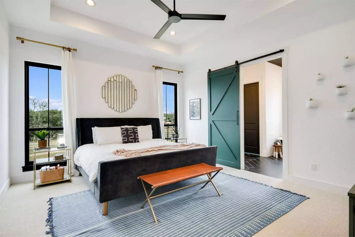 Primary Bedroom with Teal Sliding Barn Door and Black Upholstered Bed
