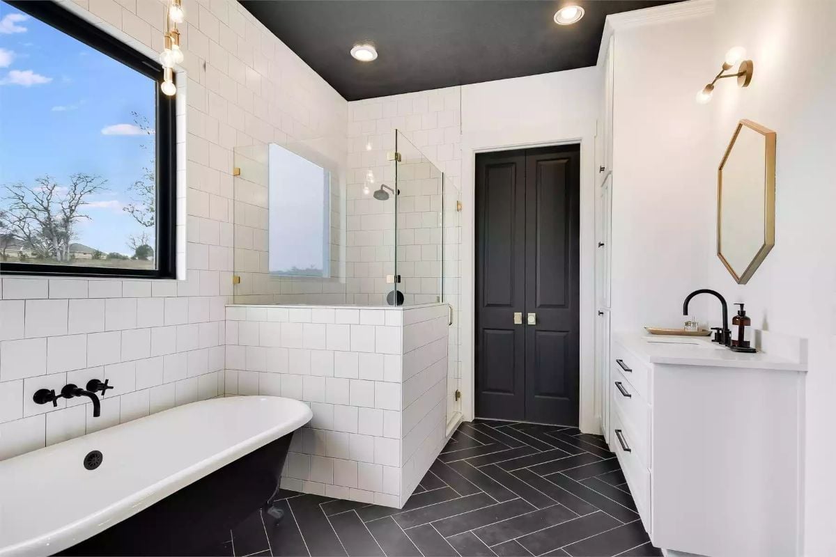 Spa-Inspired Bathroom with Herringbone Floor and Matte Black Fixtures