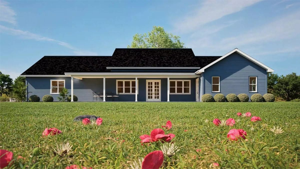 Blue Ranch Home with Covered Front Porch and Manicured Lawn