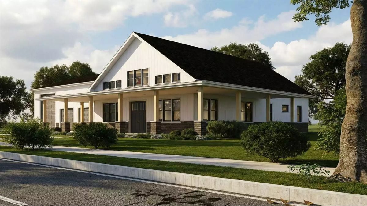 White Farmhouse Ranch with Stone-Trimmed Wraparound Porch and Black Roof