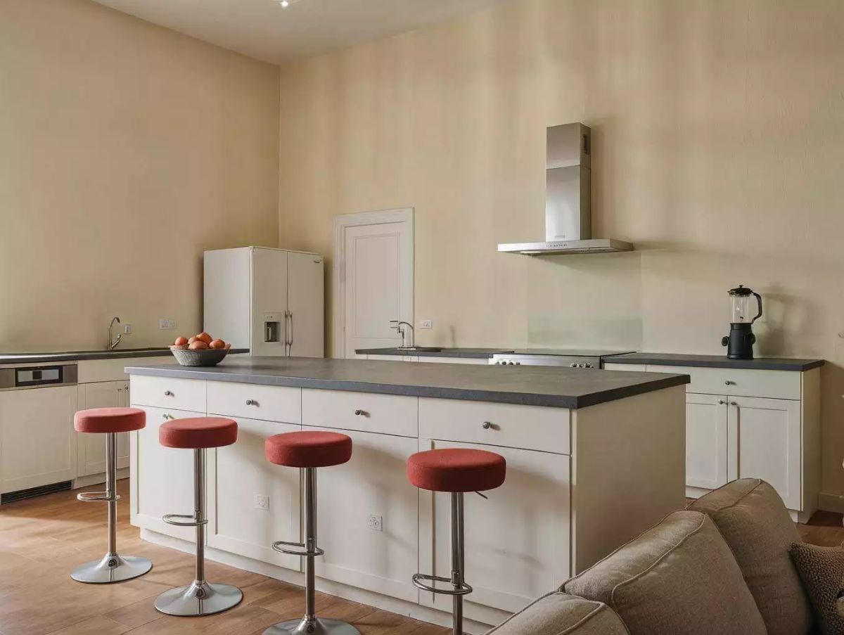 Kitchen Island with Coral Velvet Stools and Gray Concrete Countertops