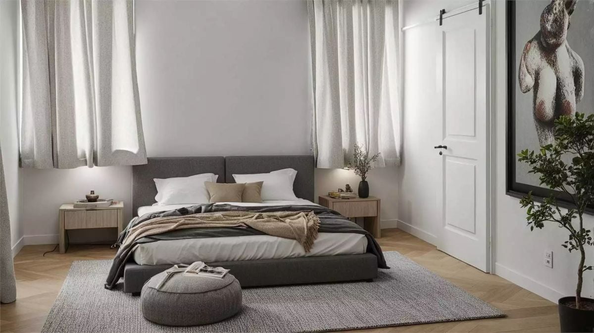Serene Bedroom with Gray Upholstered Bed and Layered Neutral Textiles