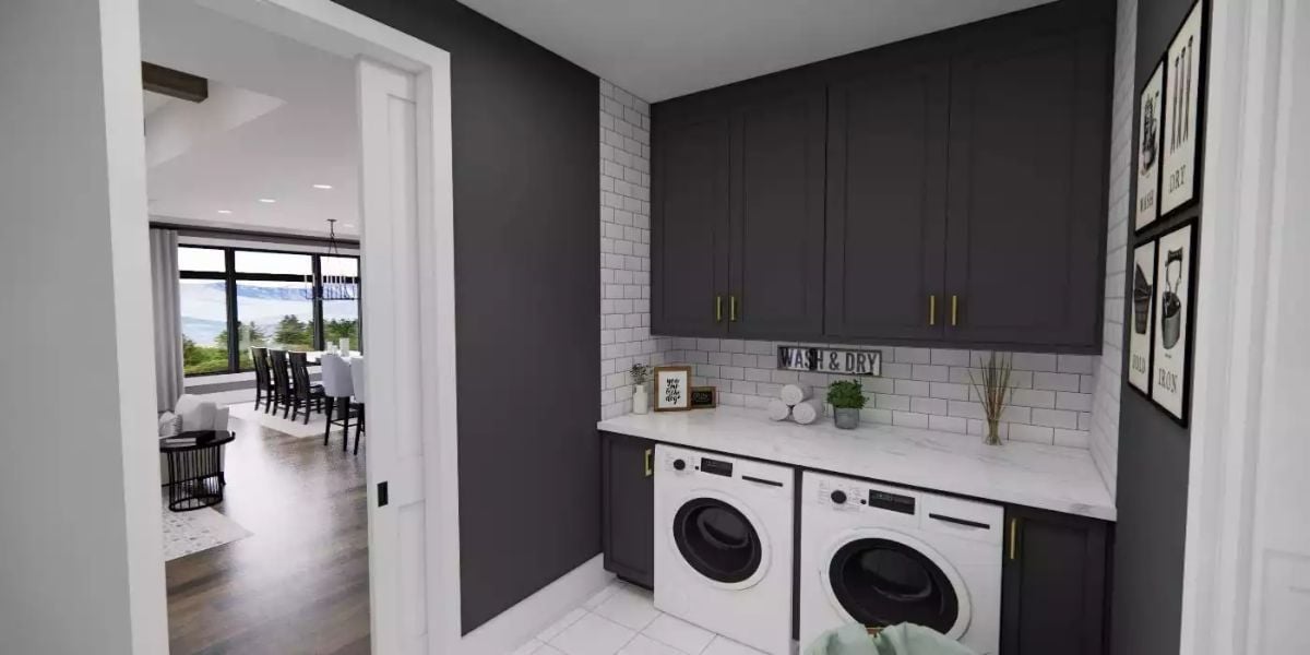 Laundry Room with White Front-Load Washer and Dryer Below Dark Cabinets