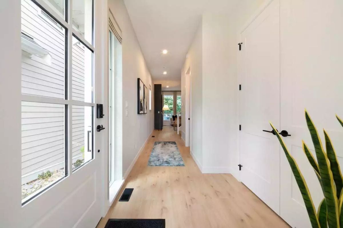 Bright Entry Hall with Light Wood Floors and Black Hardware Accents