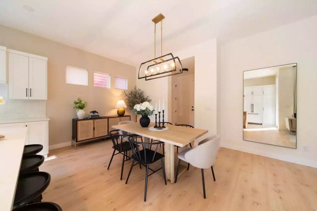 Gold-and-Black Pendant Anchors a Warm Dining Room with Mixed Seating