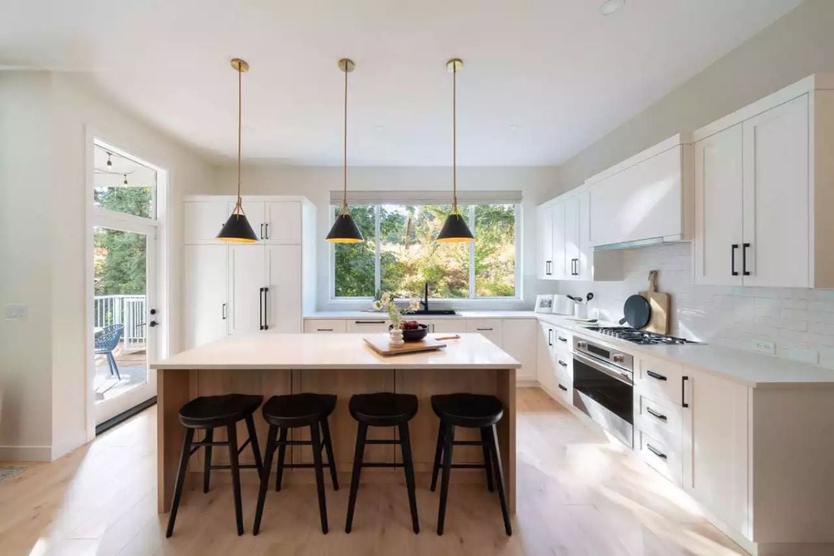 Black-and-Brass Pendants Pull Together White Cabinetry and Natural Wood Tones