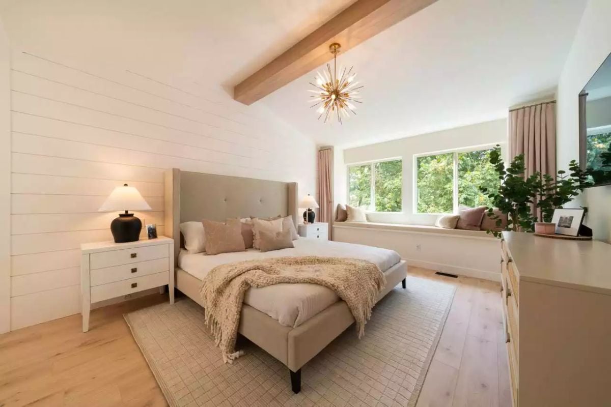 Wood Ceiling Beam and Sputnik Chandelier Define a Soft, Neutral Primary Bedroom
