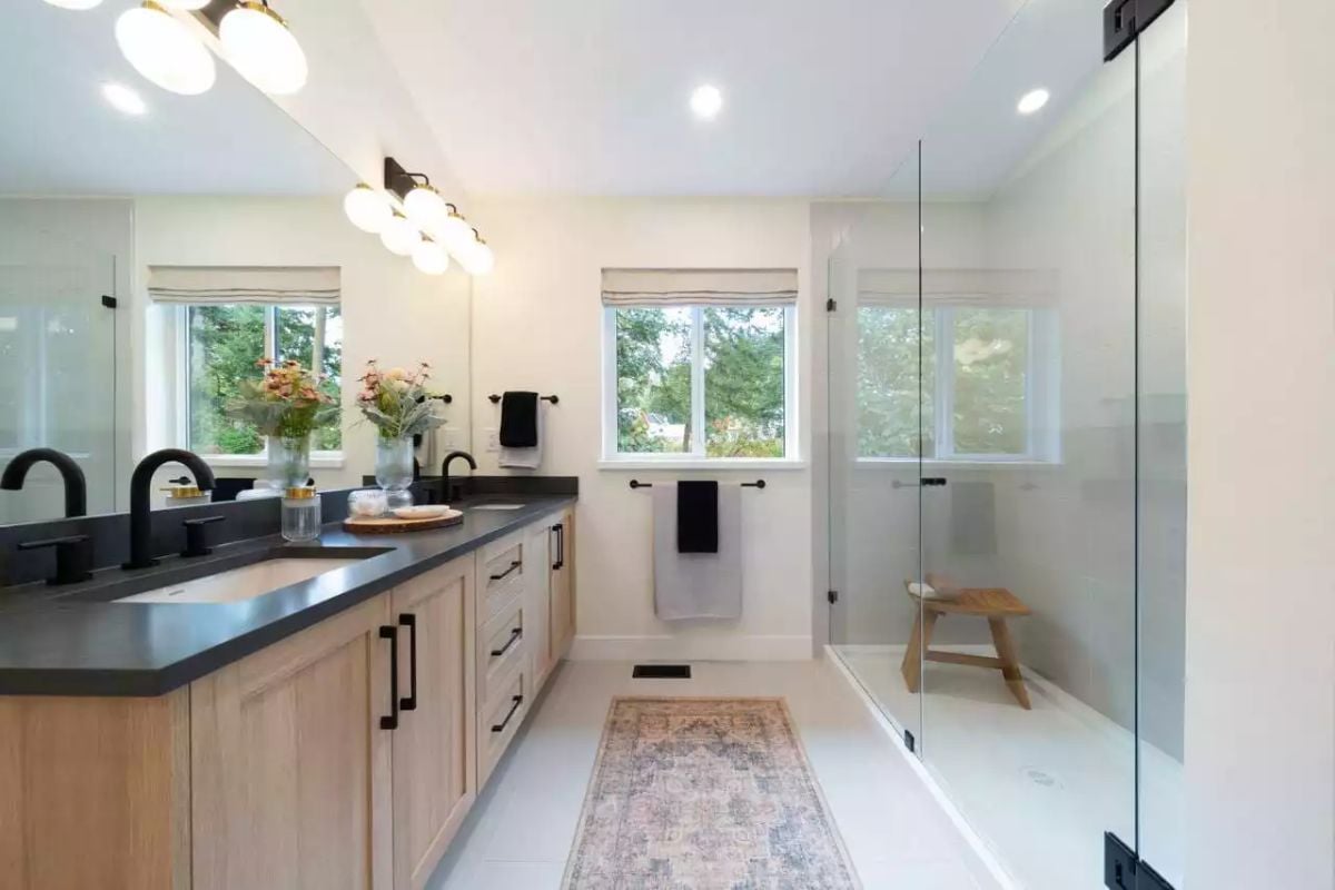 Matte Black Fixtures and Warm Wood Cabinetry Define a Modern Farmhouse Bath