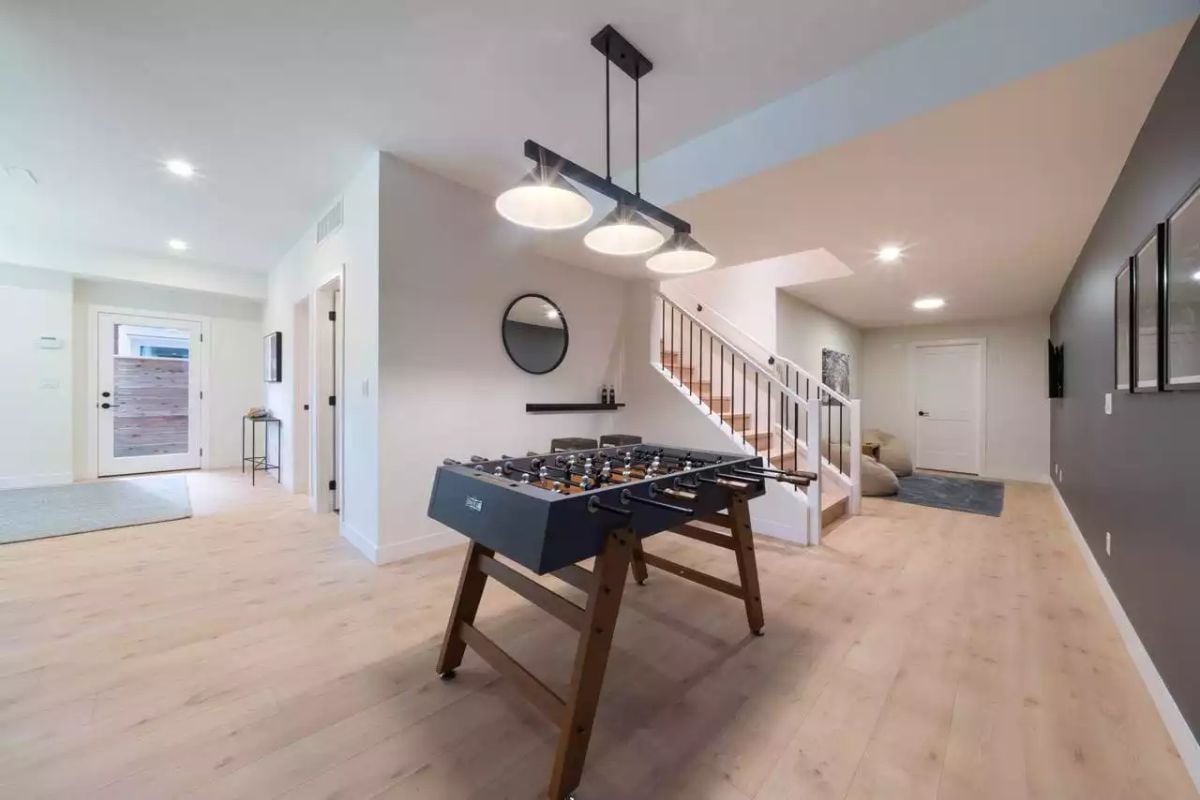 Foosball Table and Pendant Cluster Signal a Basement Built for Play