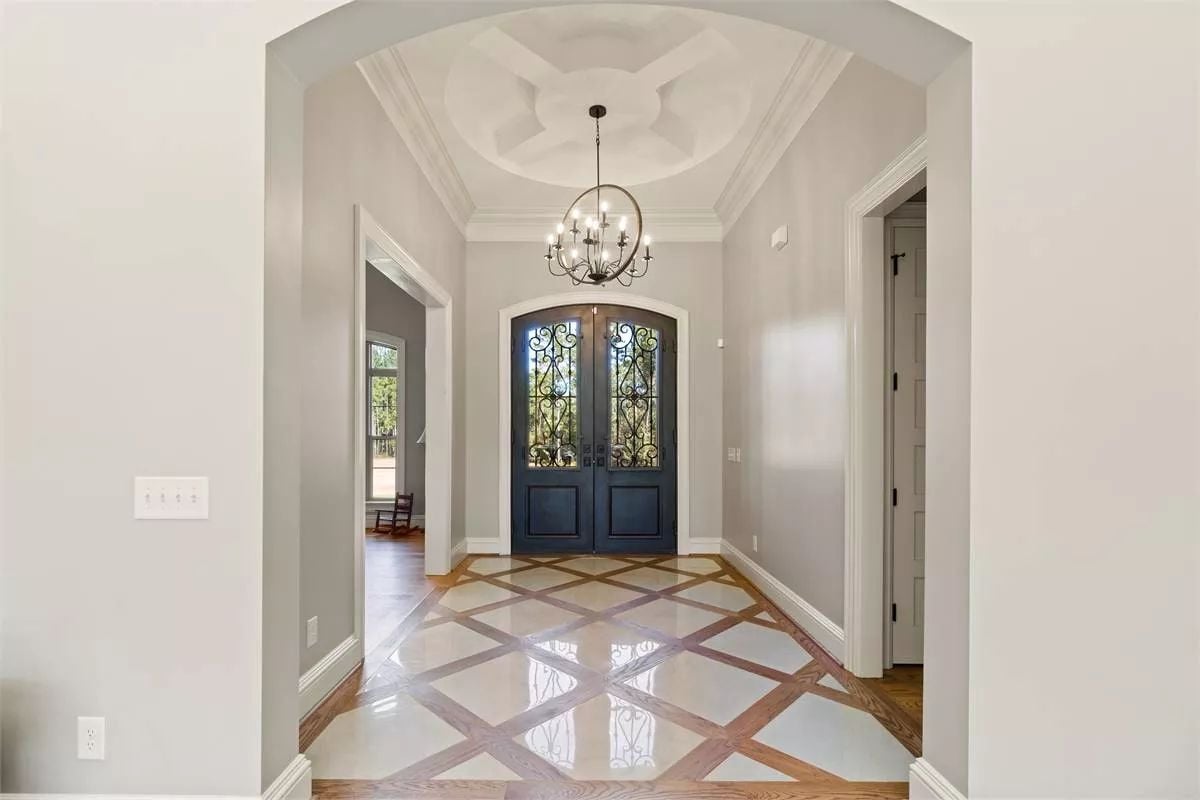 Ornate Foyer Entry with Iron Double Doors and Coffered Dome Ceiling