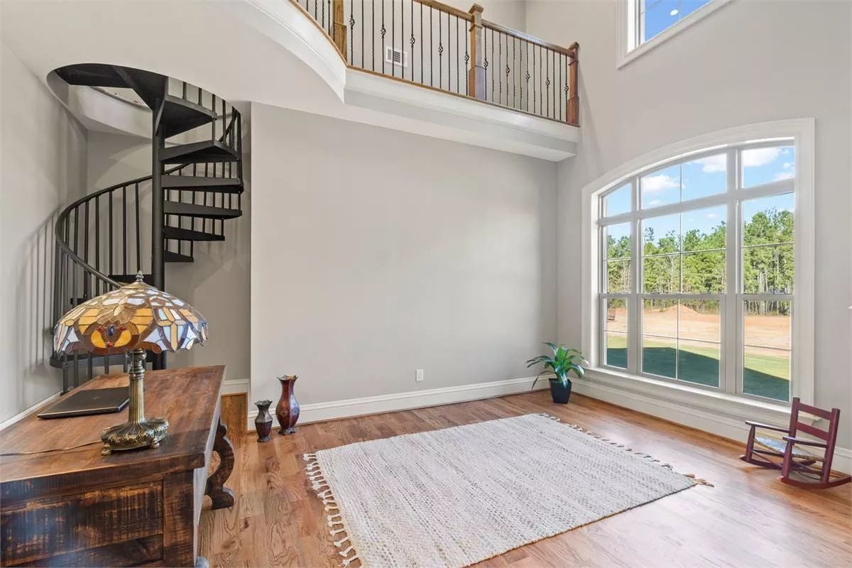 Spiral Staircase and Stained Glass Lamp Pair in This Two-Story Foyer