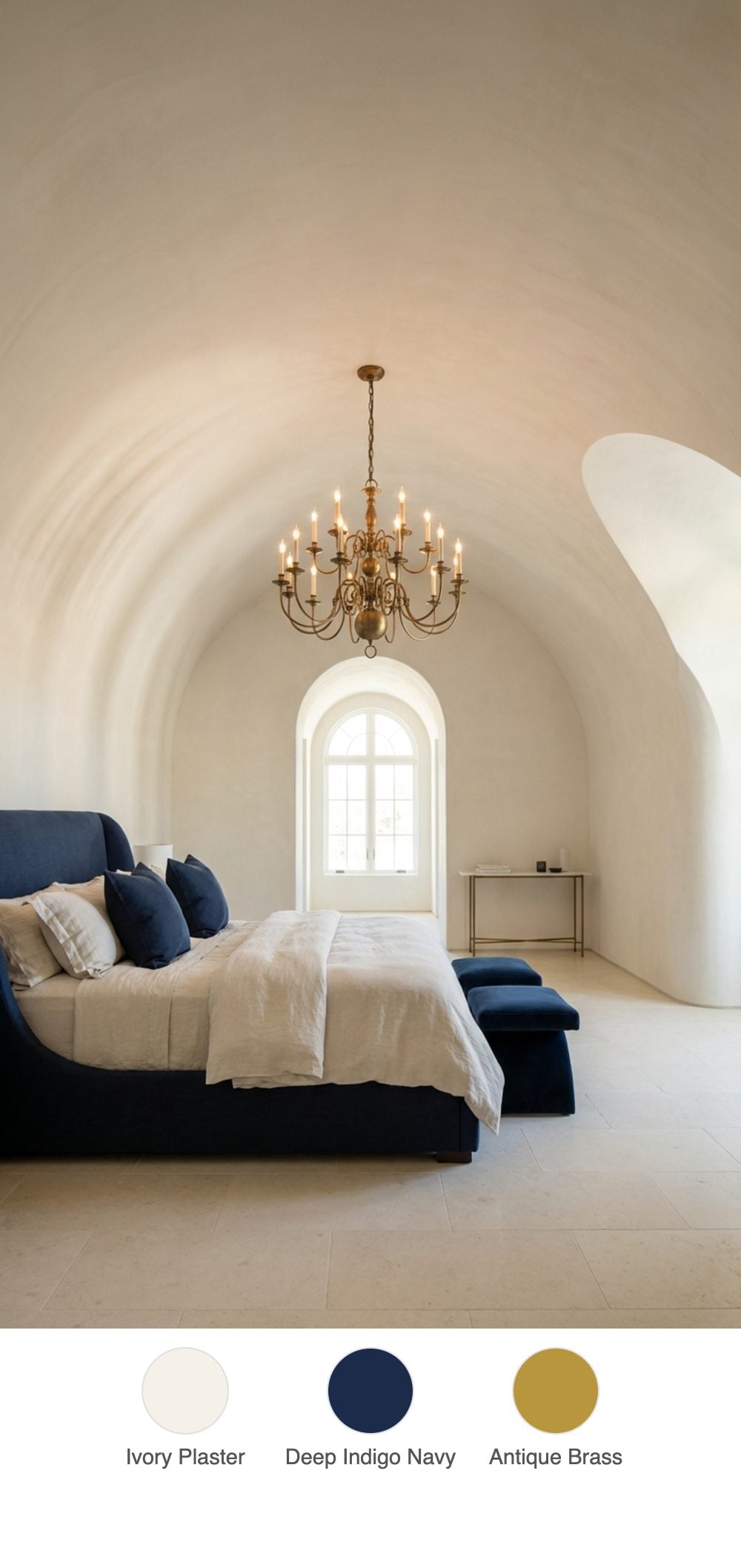 Barrel-Vaulted Ceiling Bedroom in Cream Plaster with Navy Upholstered Bed and Brass Chandelier