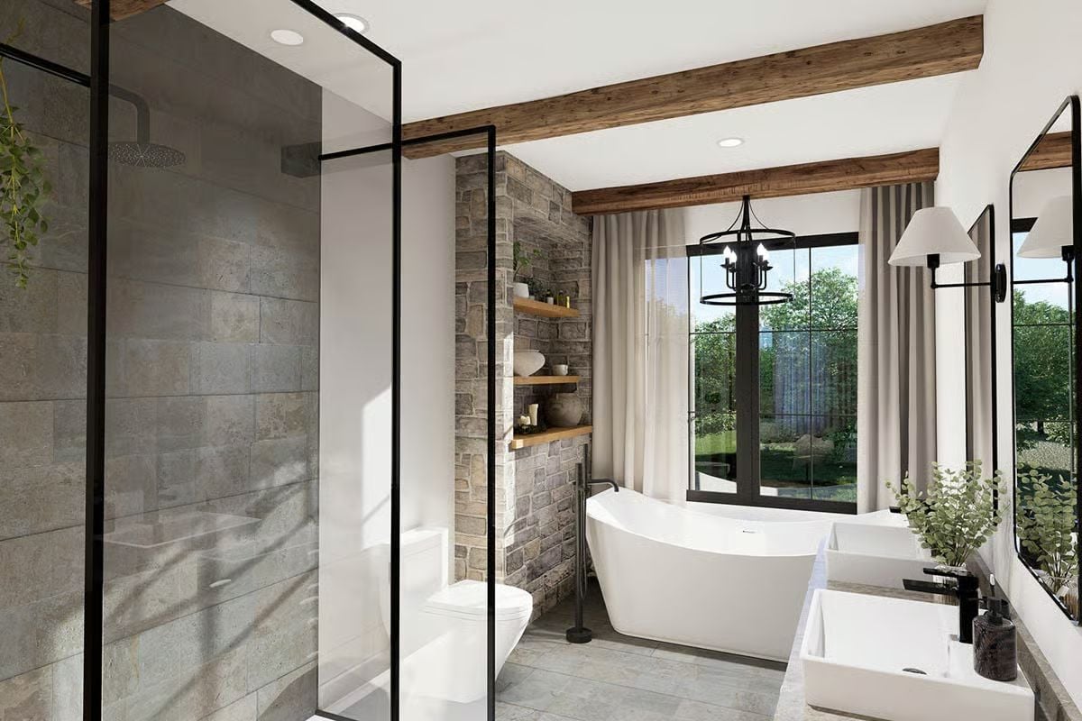 Freestanding Soaking Tub and Stone Accent Wall Anchor This Craftsman Primary Bath