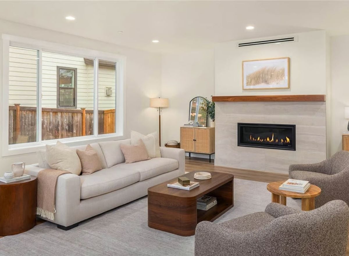 Warm Wood Tones and a Linear Fireplace Anchor This Living Room