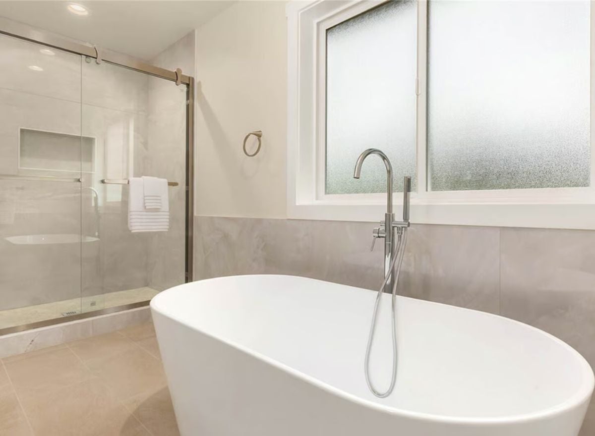 Freestanding Soaking Tub and Frosted Window Make Privacy Look Polished