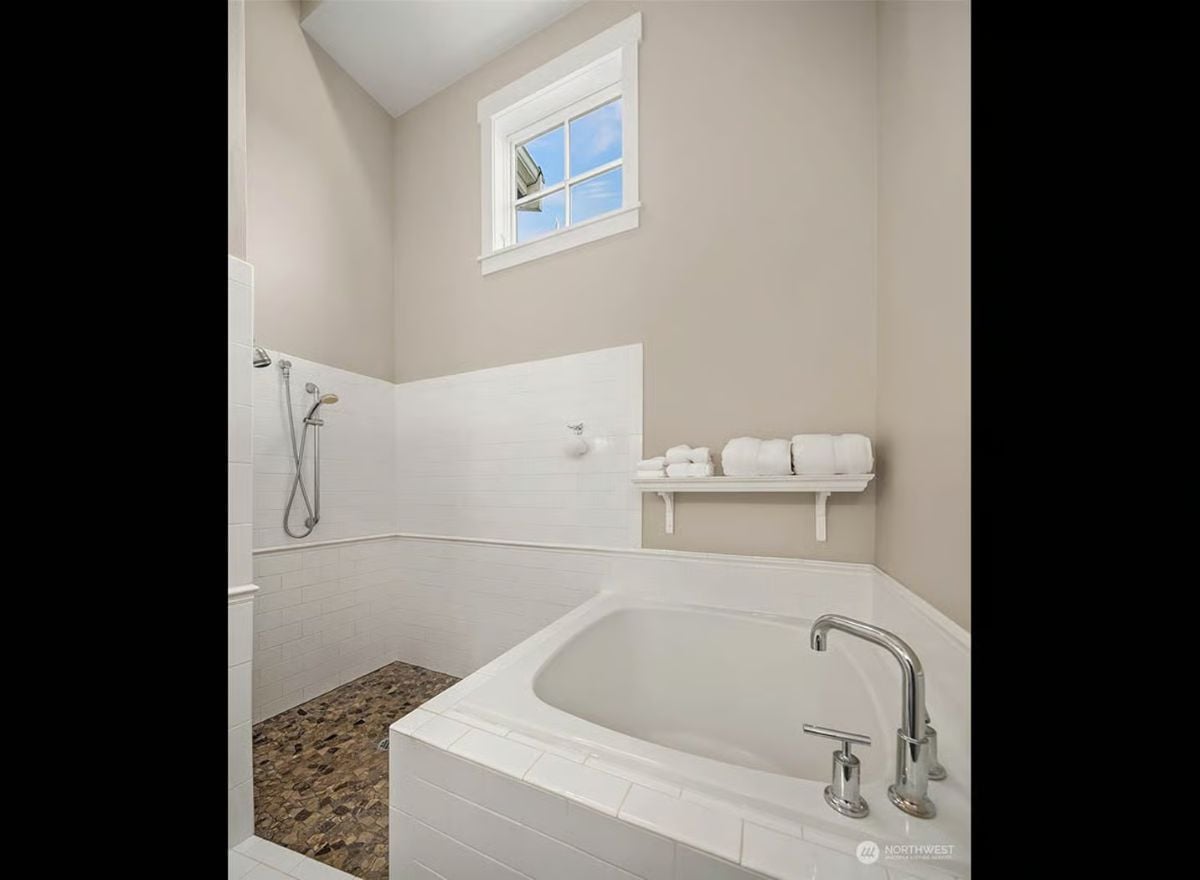Soaking Tub and Open Shower Share Space with Pebble Stone Floor