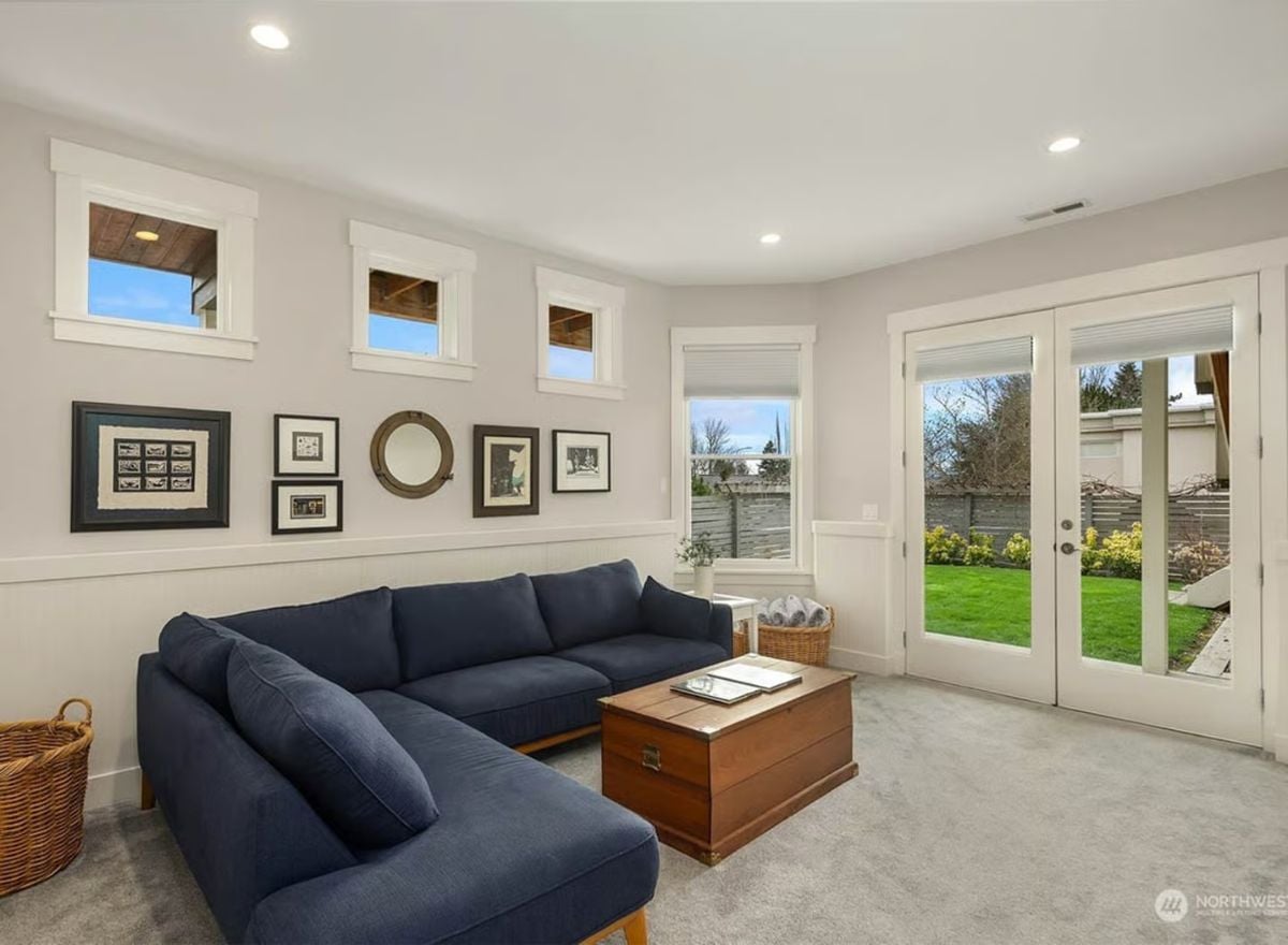 Navy Sectional and Trunk Coffee Table Ground a Bright Garden-Facing Sitting Room