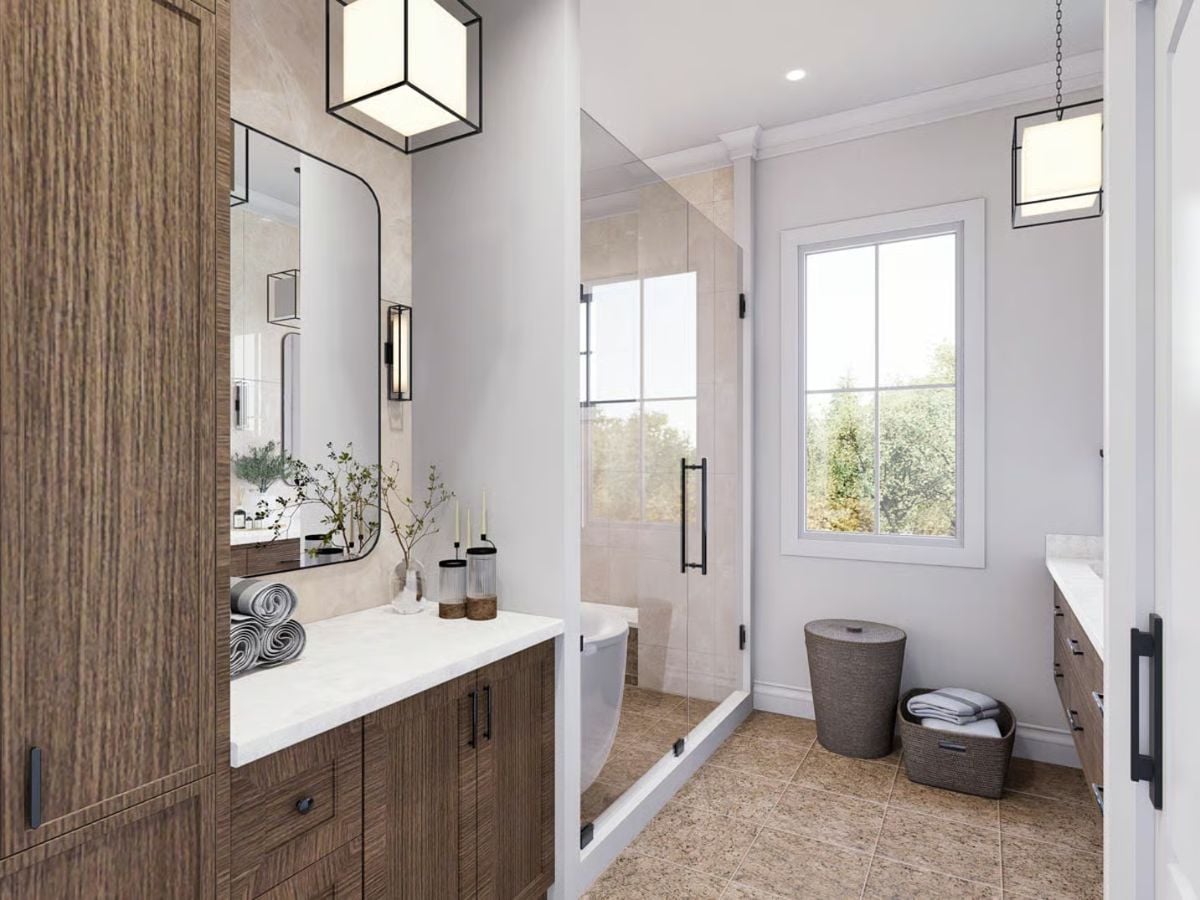 Warm Wood Cabinetry and Glass-Enclosed Shower Shape a Farmhouse Primary Bath