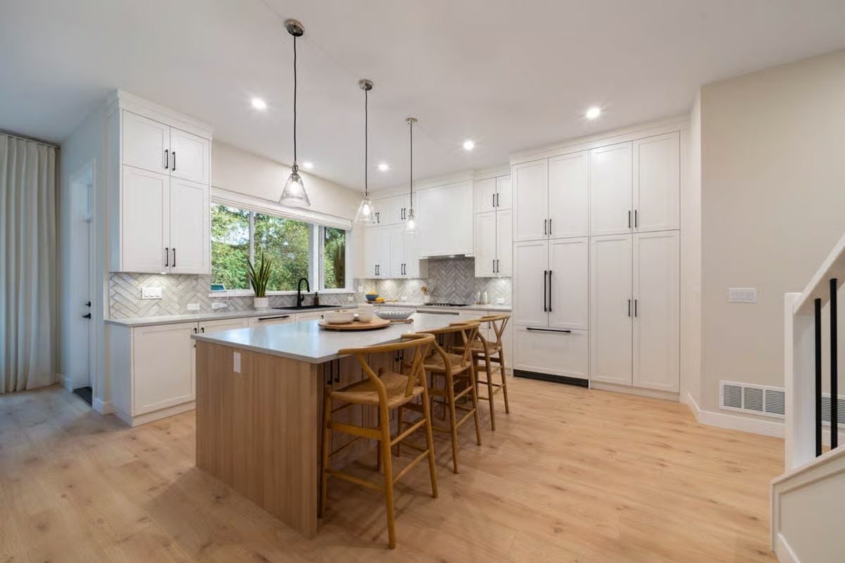 Wishbone Barstools and Wood Island Base Anchor a White Kitchen