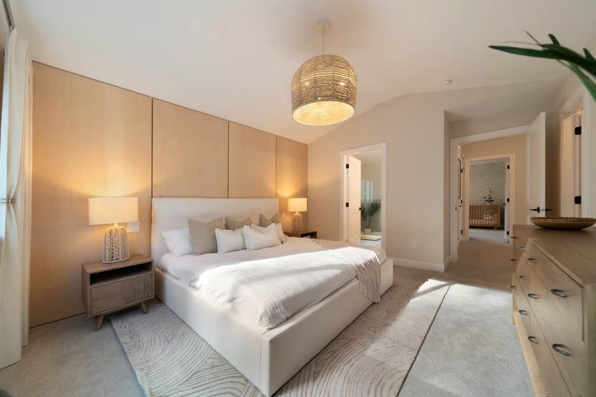 Wood Panel Accent Wall and Rattan Pendant Define a Soft Primary Bedroom