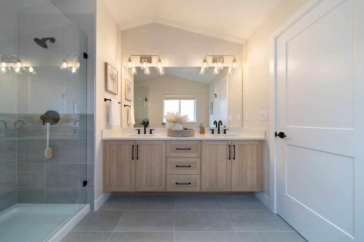 Floating Wood Vanity and Black Hardware Bring Calm to a Primary Bath