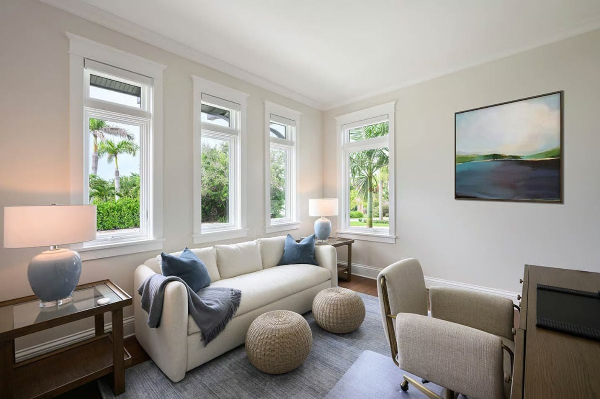 Wicker Poufs and Blue Throw Pillows Bring Casual Warmth to a Sitting Room