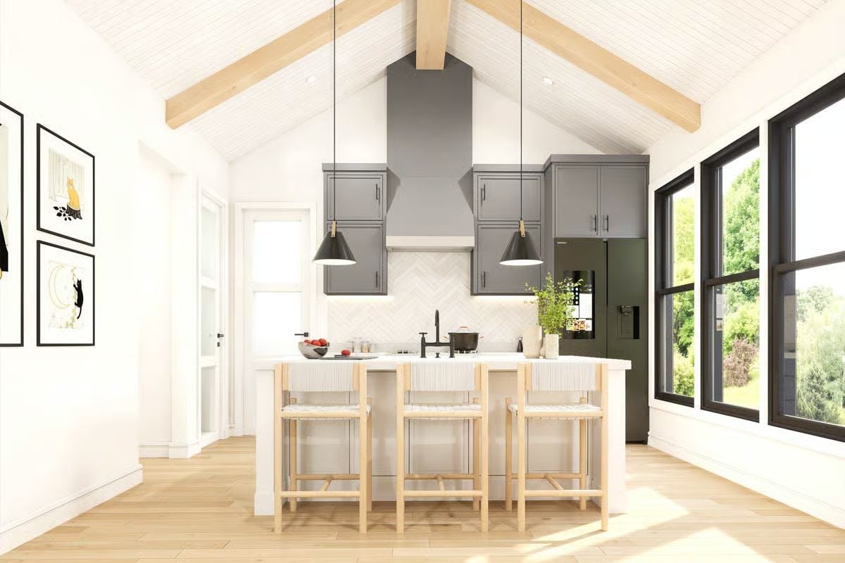 Vaulted Ceilings and Gray Cabinetry Define This Barndominium Kitchen