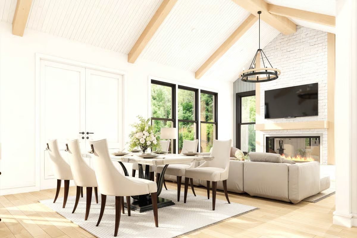 Vaulted Beams and a Stone Fireplace Anchor This Open-Plan Living Space