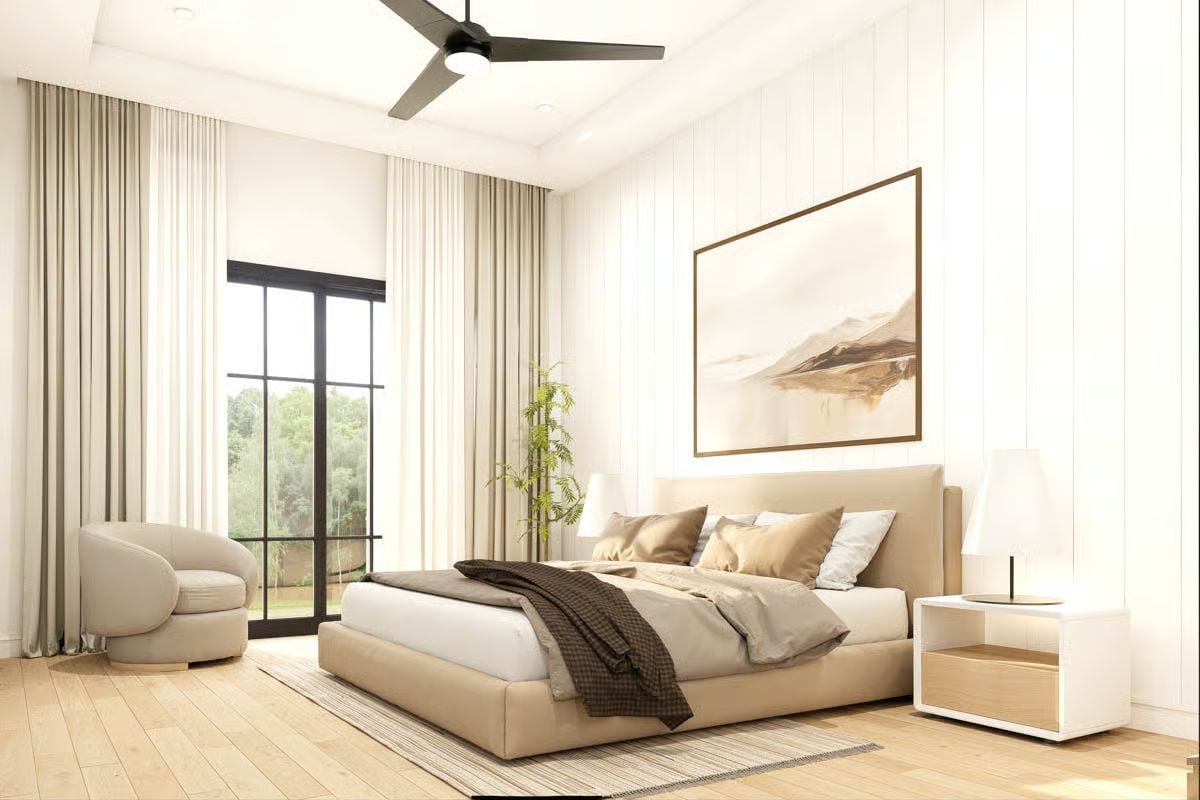 Warm Neutrals and Ceiling Fan Keep This Barndominium Bedroom Grounded