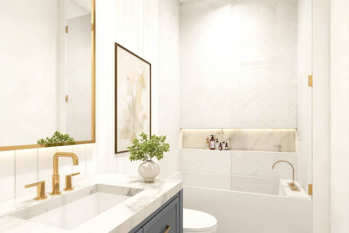 Gold Fixtures and Marble Surfaces Give This Barndominium Bath a Polished Edge