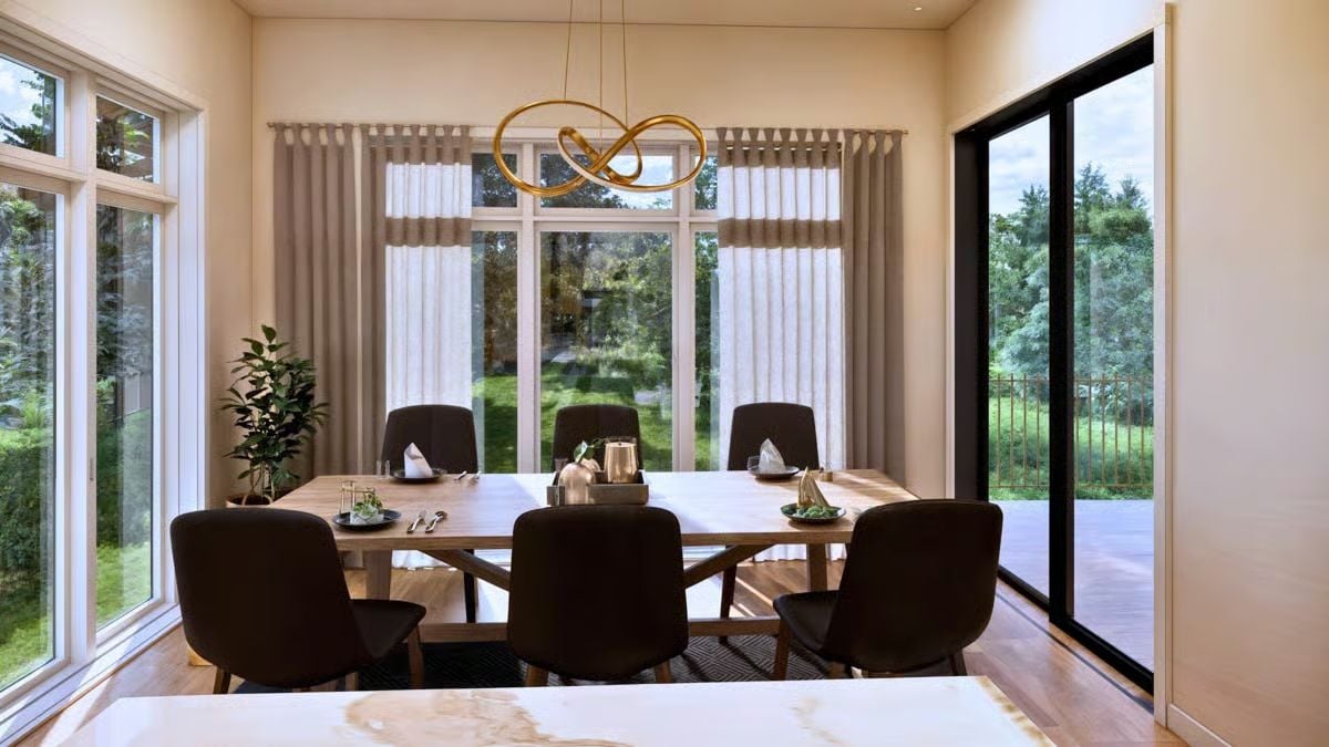Gold Knot Chandelier Anchors a Sun-Drenched Dining Room with Garden Views